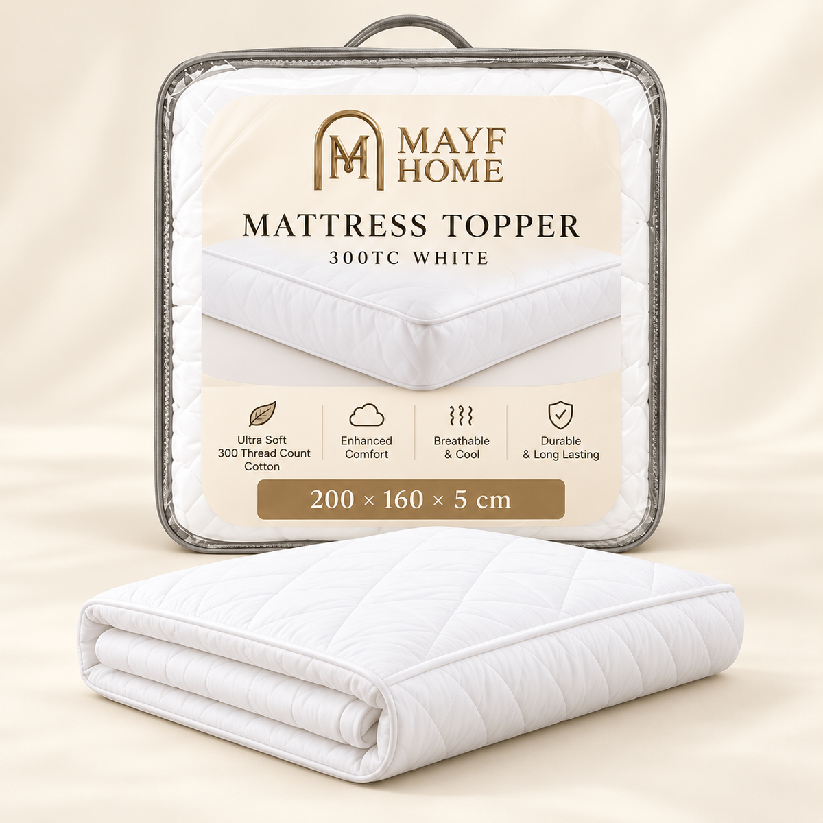 A folded white quilted mattress topper placed in front of its branded retail packaging. The package label reads 'MAYF HOME MATTRESS TOPPER 300TC WHITE' with product features and dimensions shown on a warm beige background.