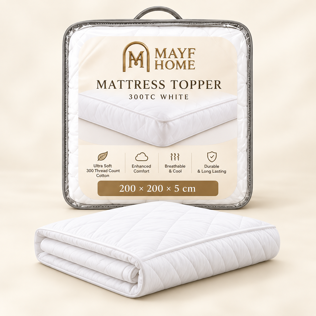 A folded white quilted mattress topper is shown in front of its retail packaging. The packaging is a clear plastic case with a printed label reading 'MAYF HOME MATTRESS TOPPER 300TC WHITE 200 x 200 x 5 cm' and feature icons.
